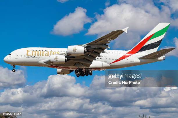 Emirates Airbus A380 aircraft as seen flying on final approach during a blue sky summer sunny day with some clouds, arriving from Dubai DXB UAE,...