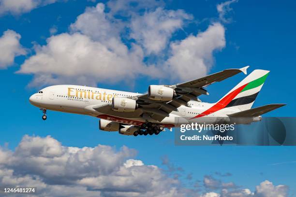 Emirates Airbus A380 aircraft as seen flying on final approach during a blue sky summer sunny day with some clouds, arriving from Dubai DXB UAE,...