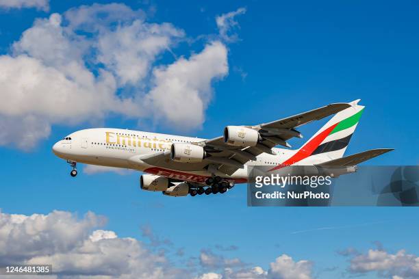 Emirates Airbus A380 aircraft as seen flying on final approach during a blue sky summer sunny day with some clouds, arriving from Dubai DXB UAE,...