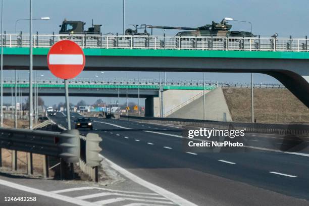 Battle tanks are seen to be transported on a trail over the highway with police escort near the border crossing with Ukraine Korczowa - Krakovets in...