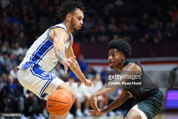 Guard MJ Collins of the Virginia Tech Hokies throws a pass around center Dereck Lively II of the Duke Blue Devils in the second half during a game at...