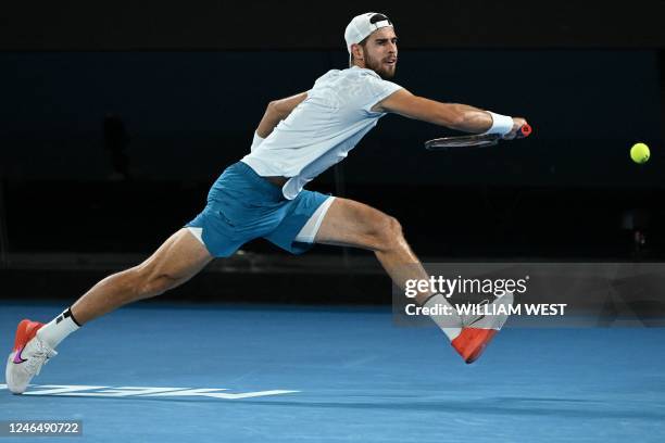 Russia's Karen Khachanov hits a return against USA's Sebastian Korda during their men's singles quarter-final match on day nine of the Australian...