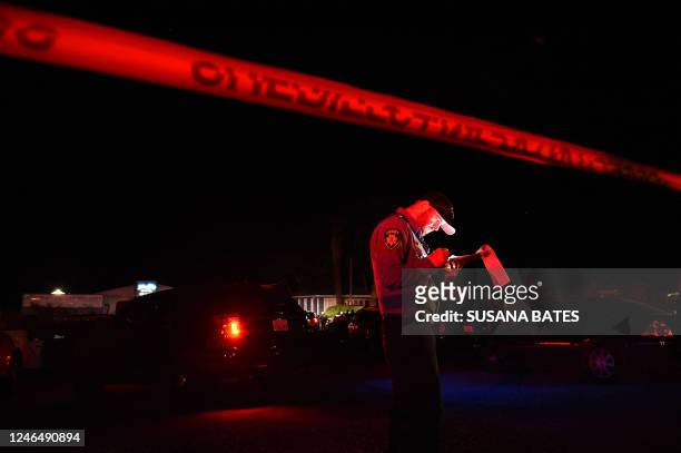 San Mateo County sheriff deputy stands at the scene of a shooting on highway 92 in Half Moon Bay, California on January 23, 2023. - An Asian farm...