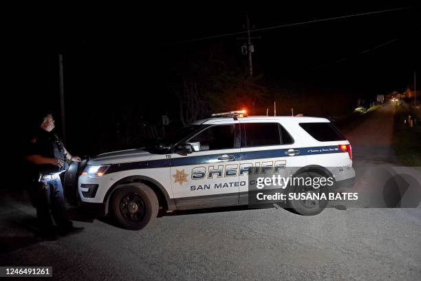 San Mateo County sheriff deputy stands guard at the scene of a shooting on highway 92 in Half Moon Bay, California on January 23, 2023. - An Asian...