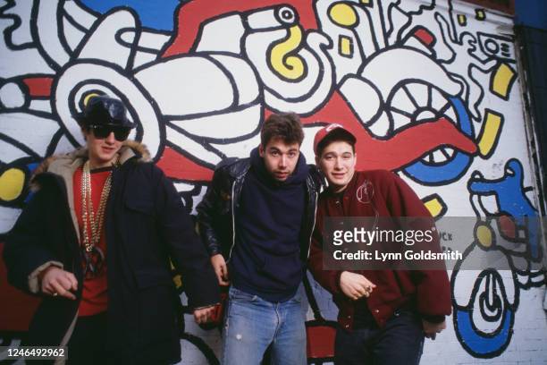 Portrait of members of American Rap group Beastie Boys as they pose in front of a mural , 1987. Pictured are, from left, Mike D , MCA , and Ad-Rock .