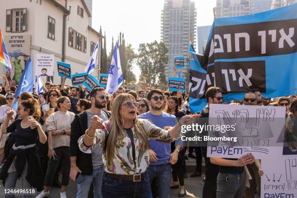 Demonstrators hold placards during a protest by tech workers against proposed judicial reforms in Tel Aviv, Israel, on Tuesday, Jan. 24, 2023....