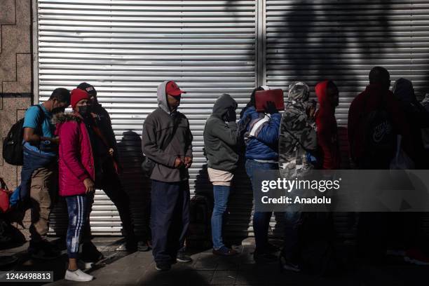 Migrants from Venezuela, Cuba, Haiti and Afghanistan wait in line outside at the Mexican Commission for Refugee Assistance in Mexico City, Mexico on...