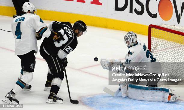 Los Angeles Kings goalie Jonathan Quick eyes the puck as San Jose Sharks goalie Martin Jones attempts to block the shot during the second period in...