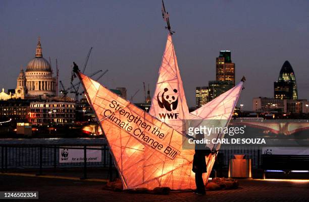 Woman signs a paper boat sculpture created by the World Wildlife Fund on the South Bank, in London, 15 November 2007. The WWF were trying to...
