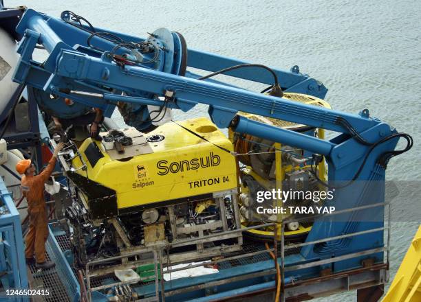 Pilot technician Nick Cregan of deepwater operations company Sonsub does a post check on the Triton 04, a remote operated vehicle used in the just...