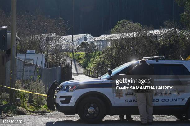 San Mateo County Sheriff wait for officers to investigate a crime scene after a shooting at the Spanish Town shops in Half Moon Bay, California, on...