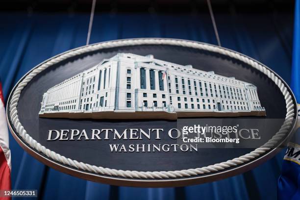 Seal of the US Department of Justice before a news conference in Washington, DC, US, on Tuesday, Jan. 24, 2023. The Justice Department and eight...