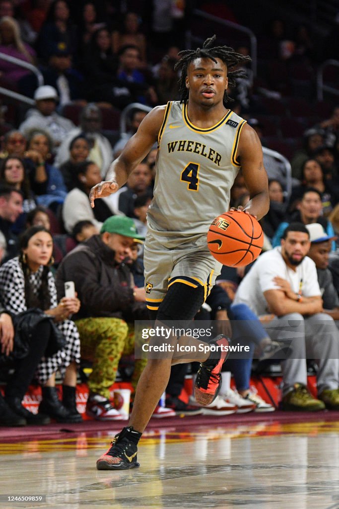Wheeler guard Isaiah Collier dribbles up the court during a high