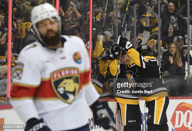 Danton Heinen of the Pittsburgh Penguins celebrates with Ryan Poehling after scoring a goal in the first period during the game against the Florida...