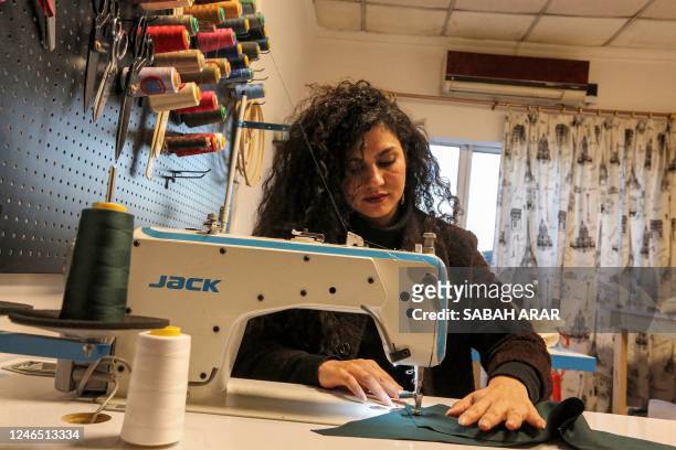 Alaa Adel, an Iraqi fashion designer, works at her "Iraqcouture" studio in the capital Baghdad, on January 11, 2023. - In a deeply patriarchal Iraq,...