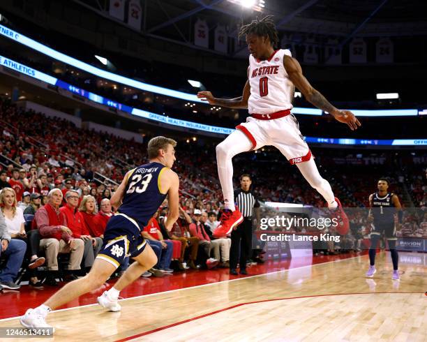 Terquavion Smith of the NC State Wolfpack jumps following a fake shot by Dane Goodwin of the Notre Dame Fighting Irish during the first half of their...