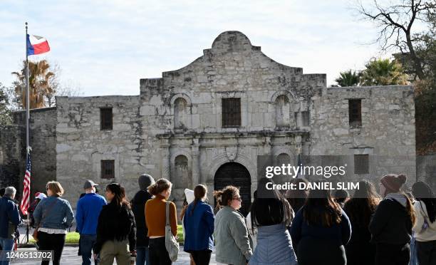 Tourists gather in front of the chapel of the Alamo Mission, known as the "Shrine of Texas Liberty", in downtown San Antonio Texas, on January 23,...