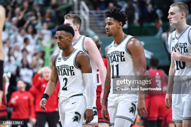 Michigan State Spartans guards Tyson Walker and A.J. Hoggard walk back to their bench during a college basketball game between the Michigan State...