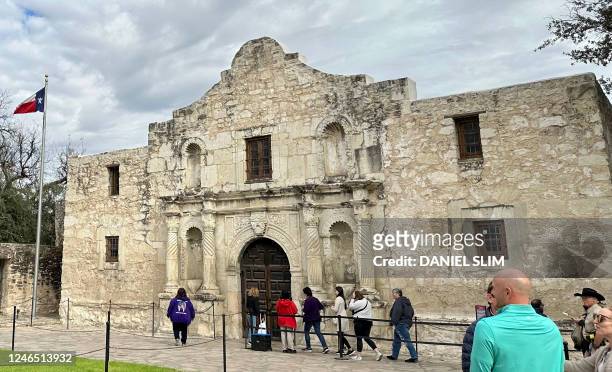 Tourists gather in front of the chapel of the Alamo Mission, known as the "Shrine of Texas Liberty", in downtown San Antonio Texas, on January 23,...