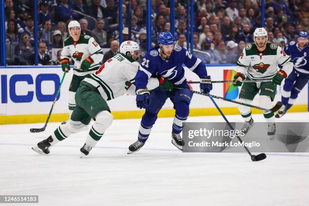 Brayden Point of the Tampa Bay Lightning skates against Jake Middleton of the Minnesota Wild during the first period at Amalie Arena on January 24,...