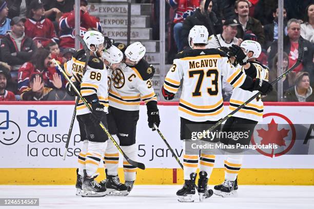 Taylor Hall of the Boston Bruins celebrates his goal with teammates David Pastrnak and Hampus Lindholm during the second period of the game against...