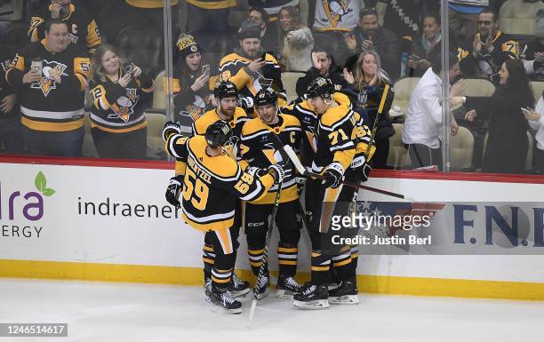 Sidney Crosby of the Pittsburgh Penguins celebrates with teammates after scoring a goal in the second period during the game against the Florida...