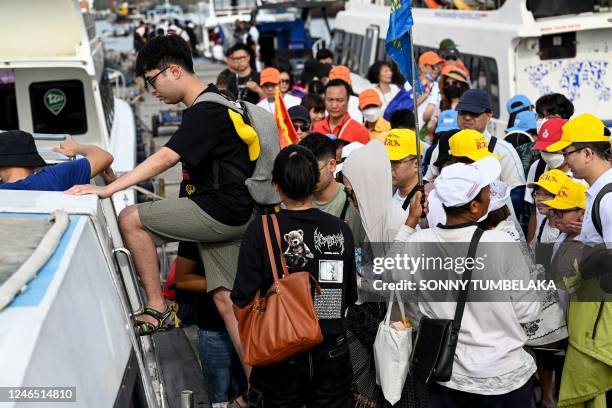 Chinese tourists board a fast boat for their trip from Serangan Island to Lombok Island in Denpasar, on Indonesia's resort island of Bali, on January...