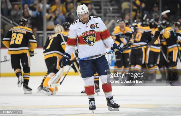 Aleksander Barkov of the Florida Panthers skates off the ice as the Pittsburgh Penguins celebrate a 7-6 win during the game at PPG PAINTS Arena on...