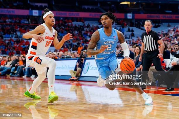 North Carolina Tar Heels Guard Caleb Love dribbles the ball against Syracuse Orange Forward Benny Williams during the first half of the College...