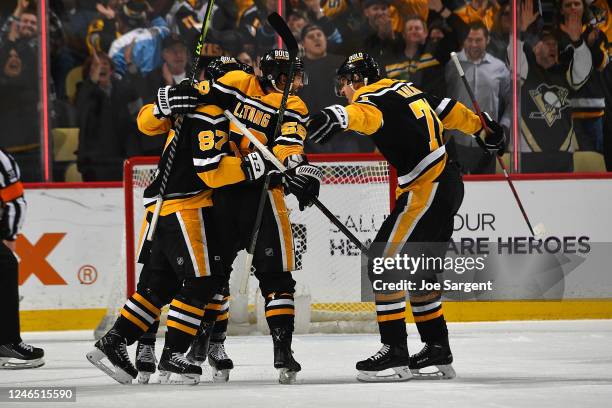 Kris Letang celebrates his overtime goal with Sidney Crosby and Evgeni Malkin of the Pittsburgh Penguins against the Florida Panthers at PPG PAINTS...