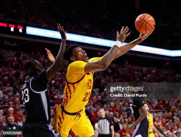 Osun Osunniyi of the Iowa State Cyclones lays up a shot as Abayomi Iyiola of the Kansas State Wildcats blocks in the first half of play at Hilton...