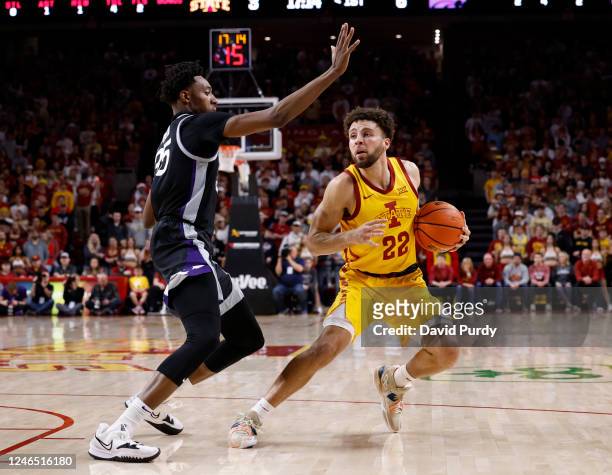 Gabe Kalscheur of the Iowa State Cyclones drives the ball as NaeQwan Tomlin of the Kansas State Wildcats blocks in the first half of play at Hilton...