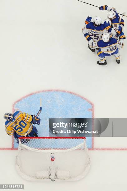 Members of the Buffalo Sabres celebrate after scoring a goal against Jordan Binnington of the St. Louis Blues in the first period of the game at...