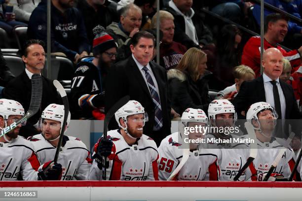 Coaches Scott Allen, Peter Laviolette and Blaine Forsythe of the Washington Capitals look on during the first period against the Colorado Avalanche...