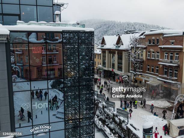 An aerial view of people walking in the city center covered in snow in Zakopane, Poland on January 22, 2023. After unusually warm weather during the...