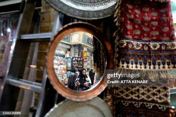 Iranians shop at the bazaar of Tajrish in northern Tehran on January 25, 2023. - The EU and Britain slapped yesterday another round of sanctions on...