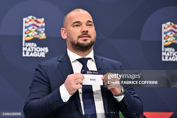 Dutch retired football player Wesley Sneijder shows the paper slip of Spain during the 2023 UEFA Nations League football finals draw in Nyon,...