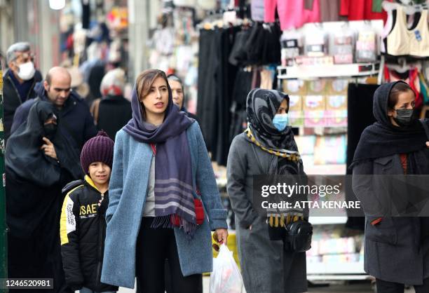 Iranian shoppers walk through the bazaar of Tajrish in northern Tehran on January 25, 2023. - The EU and Britain slapped yesterday another round of...