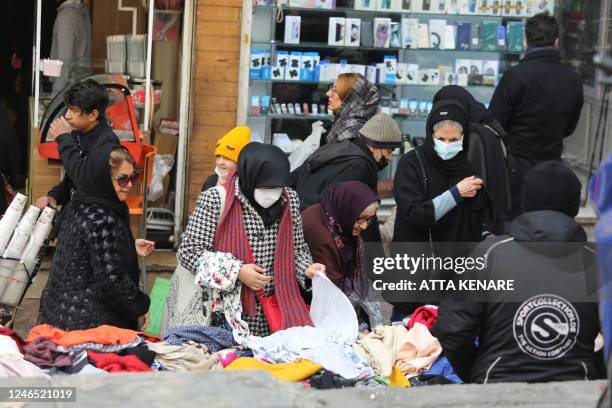 Iranian women shop at the bazaar of Tajrish in northern Tehran on January 25, 2023. - The EU and Britain slapped yesterday another round of sanctions...