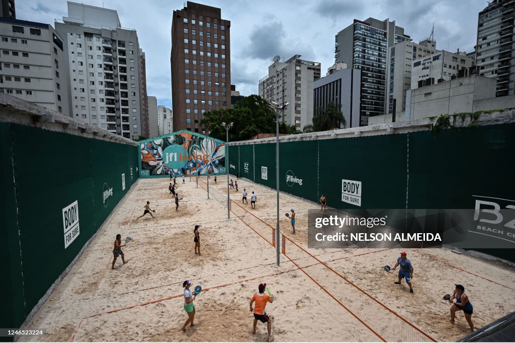People play beach tennis at a club in Sao Paulo, Brazil, on January