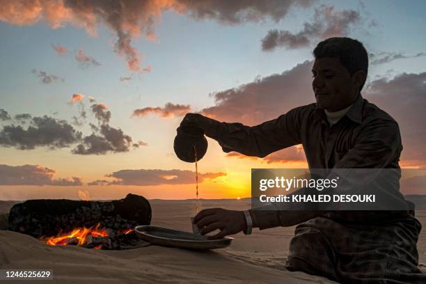 Ahmed el-Masri, a desert guide and driver, serves tea at sunset during a safari trip in the vicinity of Egypt's western desert oasis of Siwa, about...