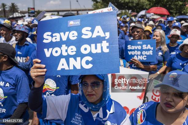 Supporters of the largest opposition party 'Democratic Alliance' hold banners and gather to protest against the ruling party 'African National...