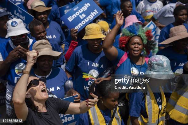 Supporters of the largest opposition party 'Democratic Alliance' hold banners and gather to protest against the ruling party 'African National...