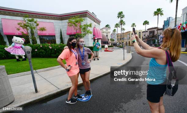 Visitors take a picture at Universal Studios theme park on the first day of reopening from the coronavirus pandemic, on June 05, 2020 in Orlando,...