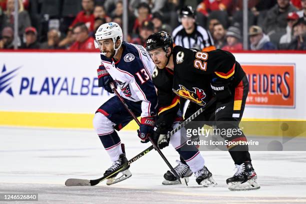 Columbus Blue Jackets Left Wing Johnny Gaudreau and Calgary Flames Center Elias Lindholm get set for a face-off during the overtime period of an NHL...