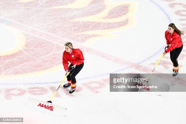 Calgary Flames ice girls clean the ice during the second period of an NHL game between the Calgary Flames and the Columbus Blue Jackets on January 23...