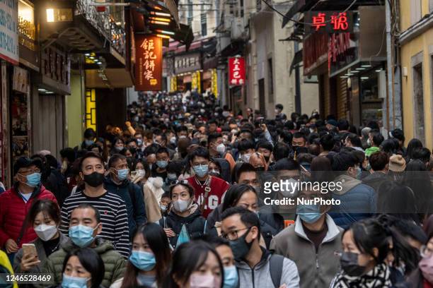 People wearing face masks walking in Senado Square on January 25, 2023 in Macau, China. This Lunar New Years marks the arrival of the year of the...