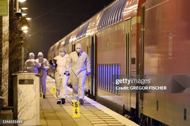 Forensic staff of the police secures and photographs evidence on the platform of the train station in Brokstedt, northern Germany, on January 25...