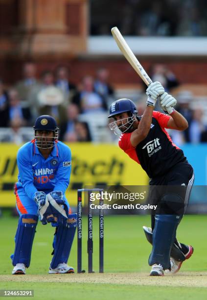 Ravi Bopara of England hits out as MS Dhoni of India watches from behind the stumps during the 4th Natwest One Day International match between...