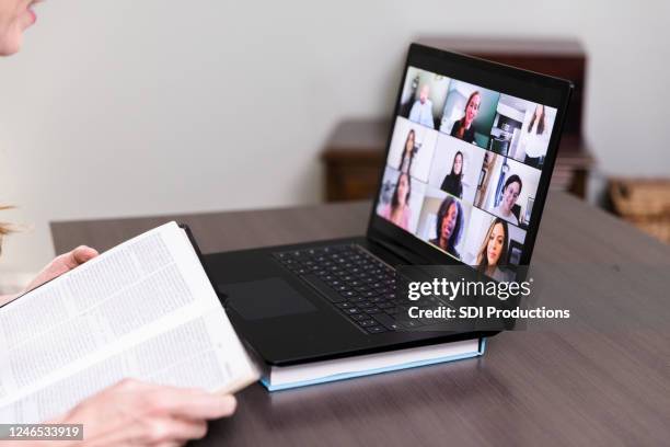 unrecognizable person teaches bible study via video - theology stock pictures, royalty-free photos & images